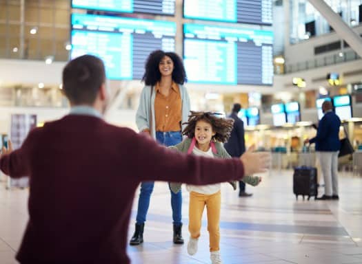 Child running to father in airport