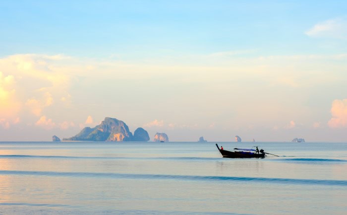 Beach with Wooden Boat and sunset at Krabi, Thailand