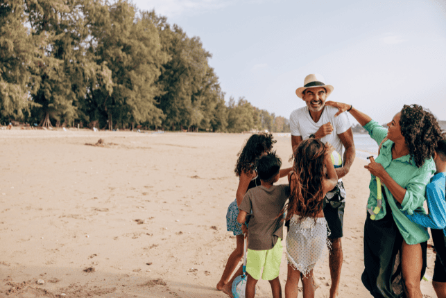 man with family on the beach