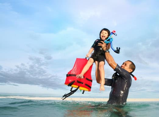 Boy and father in the ocean
