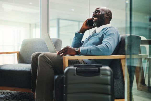man on phone in airport lounge